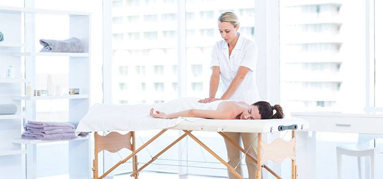 hard working massage therapist practices on client