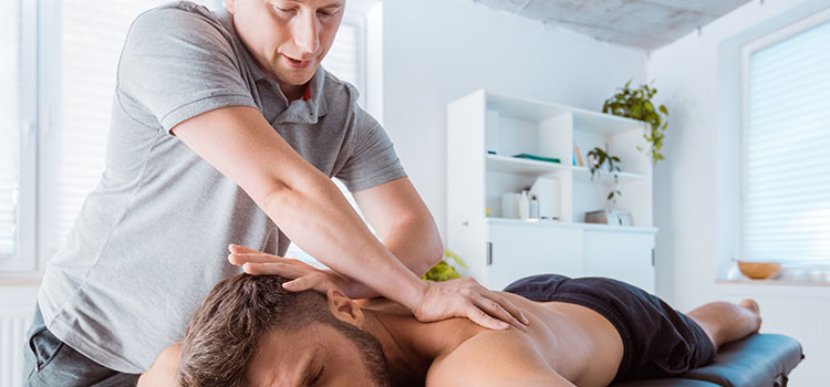 male masseuse giving man deep tissue massage