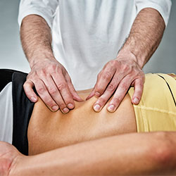 man massaging patient back muscles