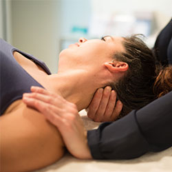 woman having nech stretched and massaged