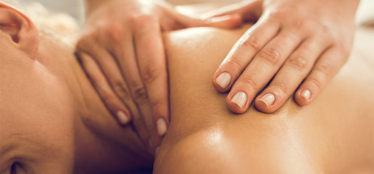 closeup of intense shoulder massage on reclining patient