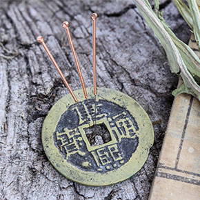 acupuncture symbol with needles sticking out