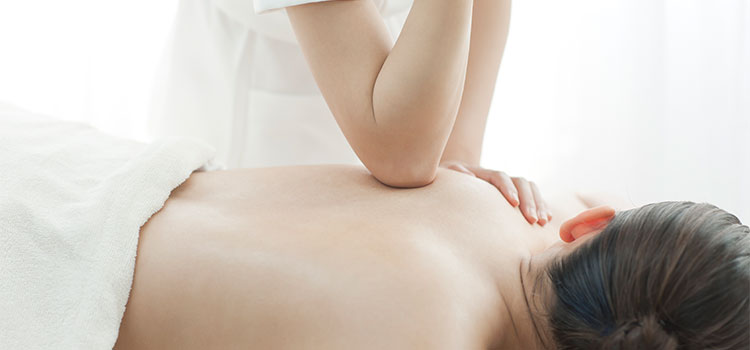 therapists elbow presses into laying patients shoulder