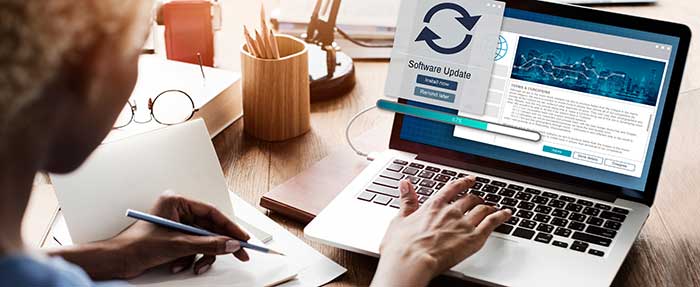 woman updates software on laptop