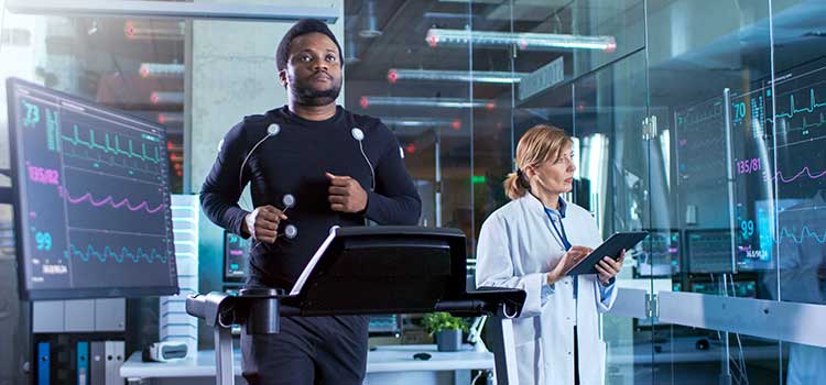 man on treadmill has heart monitored by exercise scientist
