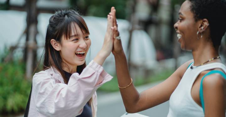 students happy to have passed the pta exam high-five each other