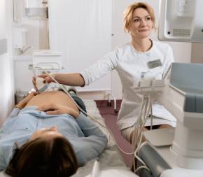 an obgyn performing ultrasound on pregnant woman at hospital