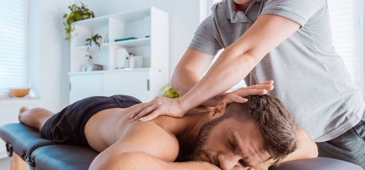 male-athlete-getting-an-upper-back-massage