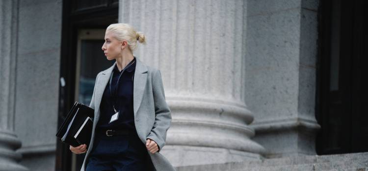 female DO walking down the steps of a huge government building