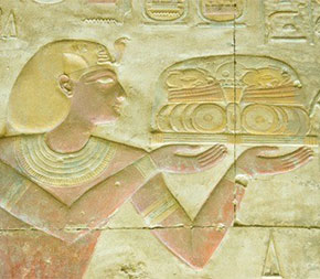 ancient carving of person holding plate of food