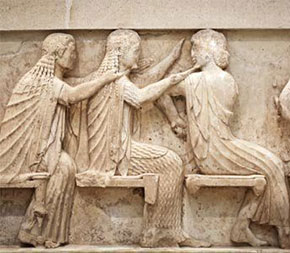 ancient stone carving showing people doing massage