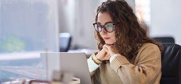 woman studies to get bachelors on laptop