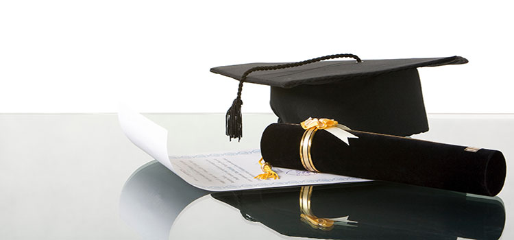 mortarboard and diploma signifying bachelors degree